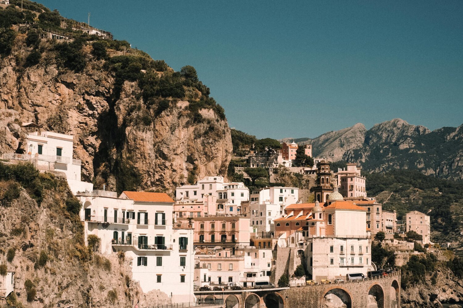 Scenic view of Amalfi Coast vertical village with historic stone bridges and Mediterranean sea